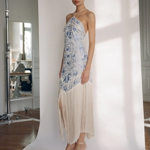 Elegant halter neck dress with blue floral print and long white fringe hem detail