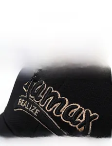 Macro detail of gold Remax embroidery on a black twill cotton baseball cap texture