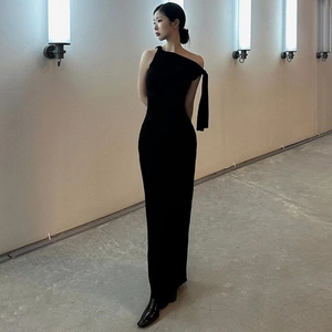 Detail of the elegant one-shoulder strap and slim fit cut of this black maxi dress