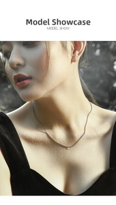 Close-up of minimalist S925 sterling silver snake chain necklace on model neck