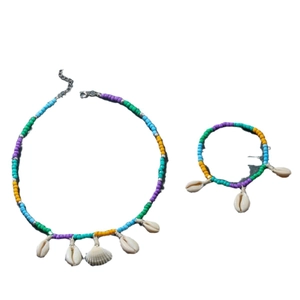 Bohemian style necklace and bracelet set featuring colorful beads and natural seashells