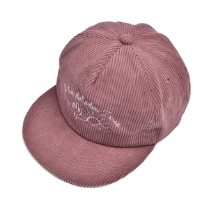Detail of white cactus embroidery on dusty rose corduroy baseball cap with text
