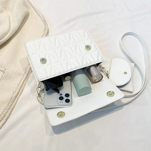 White quilted crossbody bag with golden buckle showing inner storage and mini purse