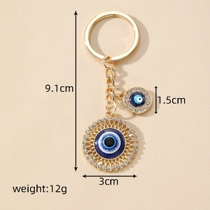 Retro Evil Eye keychain with blue crystal heart pendant in gold plated metal finish
