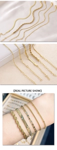 Close-up of five layered gold-plated bracelets featuring snake, rope, and curb chain styles