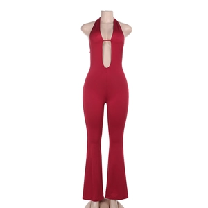 Detailed close-up of dark red halter neck jumpsuit with deep V-neckline and hollow out design