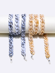 Two-pack acrylic glasses chain in grey marble and amber tones on minimalist white stand