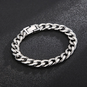 Detailed view of silver polished stainless steel Cuban link bracelet with clasp on black background