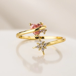 18K gold plated ring with pink heart zircon and sparkling star on minimalist background