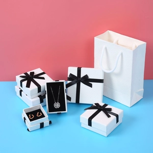 Minimalist white textured jewelry gift box set with elegant black silk bows and carry bag