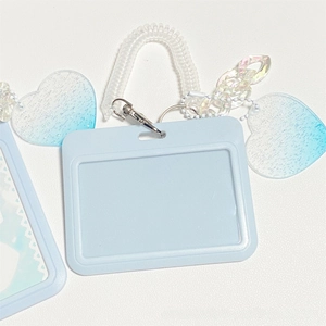 Detailed view of light blue horizontal card holder set with heart glitter charms