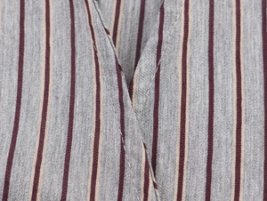 Close-up of V-neck collar and grey vertical stripe fabric texture with neat stitching