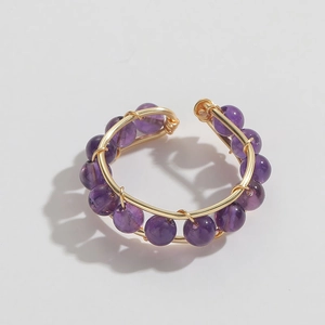 Macro shot of 14K gold plated wire wrapped ring with natural purple amethyst beads