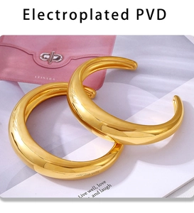 Close-up of C-shaped gold bangle showing high-polished PVD coating on magazine