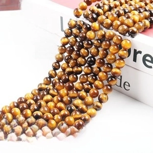Detailed view of natural eagle eye stone round beads with chatoyant silk luster