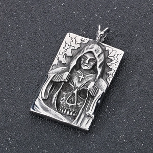 Macro detail of gothic stainless steel pendant featuring a hooded skull and reaper design