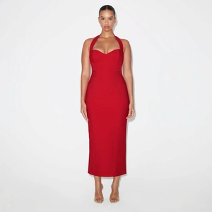 Detailed view of a red halter neck midi dress featuring a structured bandeau and side slit