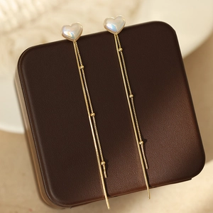 Elegant gold heart earrings with iridescent pearl inlay and long tassel chains