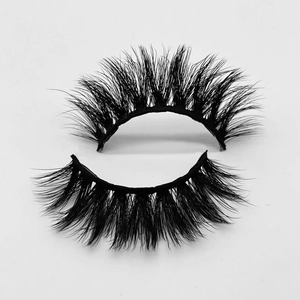 Detailed close-up of 3D layered black faux mink eyelashes with natural curl on white background