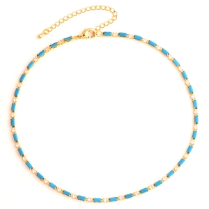Detailed view of gold necklace with turquoise rectangular beads and sparkling zircon stones