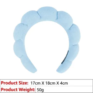 Macro view of light blue padded spa headband showing 17x18x4cm dimensions and 50g weight