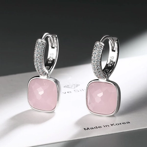 Detailed macro view of S925 silver hoop earrings with square pink gemstone and cubic zirconia