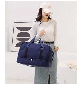 Detail of navy blue travel bag featuring wet-dry separation and bottom expansion layer