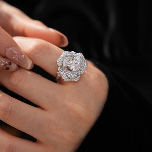 Macro shot of silver-tone rose ring with sparkling zircon pavé and oval center stone