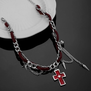 Close-up of punk choker with red cross pendant and silver chain fringe details