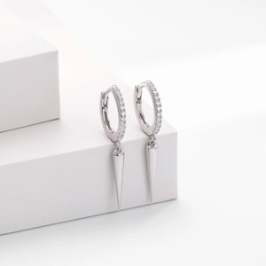 Macro shot of S925 sterling silver hoop earrings with pavé stones and spike charms