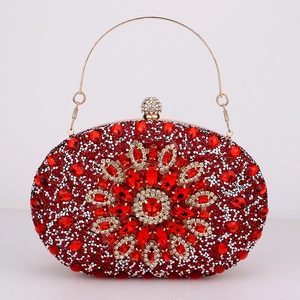 Detail of red rhinestone evening bag with floral crystal pattern and gold metal handle