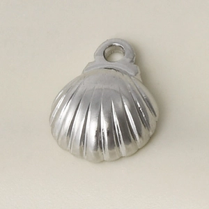 Detailed macro view of a polished stainless steel seashell pendant charm for DIY jewelry