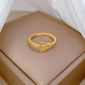 Detail of gold ginkgo zircon ring with Roman numeral design on velvet box