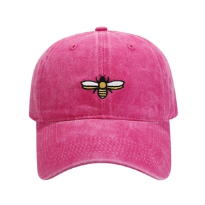 Close-up of a detailed bee embroidery on a vintage washed cotton baseball cap