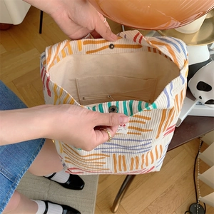 Detailed interior of corduroy tote bag showing magnetic closure and striped pattern