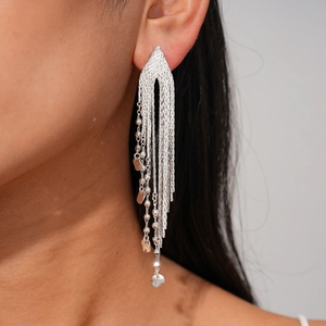 Detail of long multi-layered silver tassel earrings with delicate metal chain fringe texture