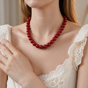 Elegant round red glass bead necklace for women styled with vintage lace clothing