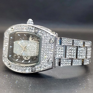 Macro shot of luxury iced-out tonneau watch with sparkling crystals on case and band