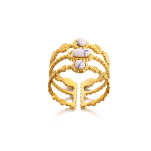 Detailed view of triple-layered golden ring featuring textured bands and white stones
