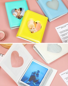 Detail view of colorful heart-hollowed photocard albums with glossy PVC finish