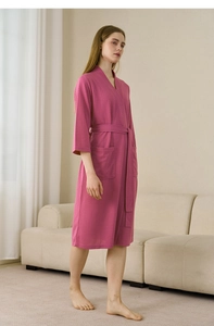 Detail of rose pink waffle texture bathrobe with matching belt and side pockets