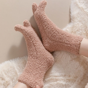 Close-up of soft coral fleece five-finger socks with warm plush texture and split-toe design
