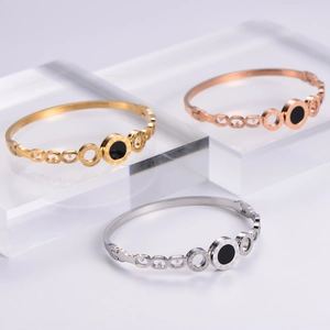 Rose gold titanium steel Roman numeral bracelets set on clear display blocks