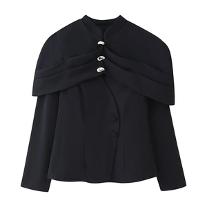 Detail of black jacket featuring draped shawl collar design and unique gold metal buttons