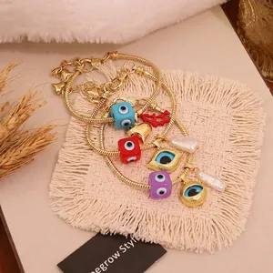 Bohemian gold snake chain bracelet with evil eye charms, heart, and baroque pearls