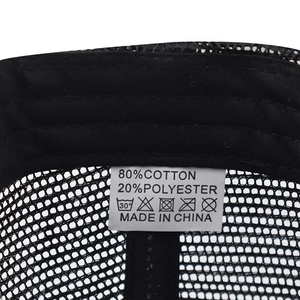 Detail view of cotton blend washing label and mesh lining on a black trucker cap