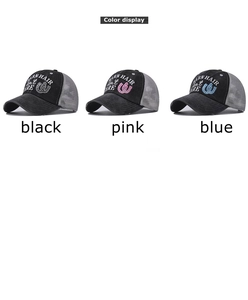 Detailed embroidery of BARN HAIR DON'T CARE text on mesh ponytail baseball caps