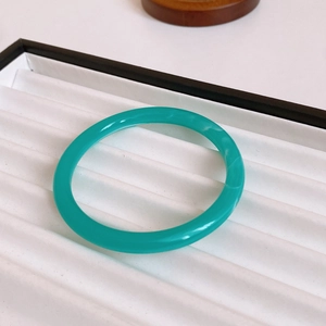 Macro detail of gold plated mother of pearl cuff bangle with turquoise resin texture