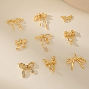 Golden bow jewelry pendants with zircon stones and heart charms for DIY necklace making
