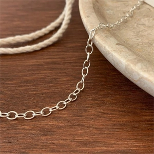 Minimalist 925 sterling silver O-link chain necklace displayed on a rustic wood surface